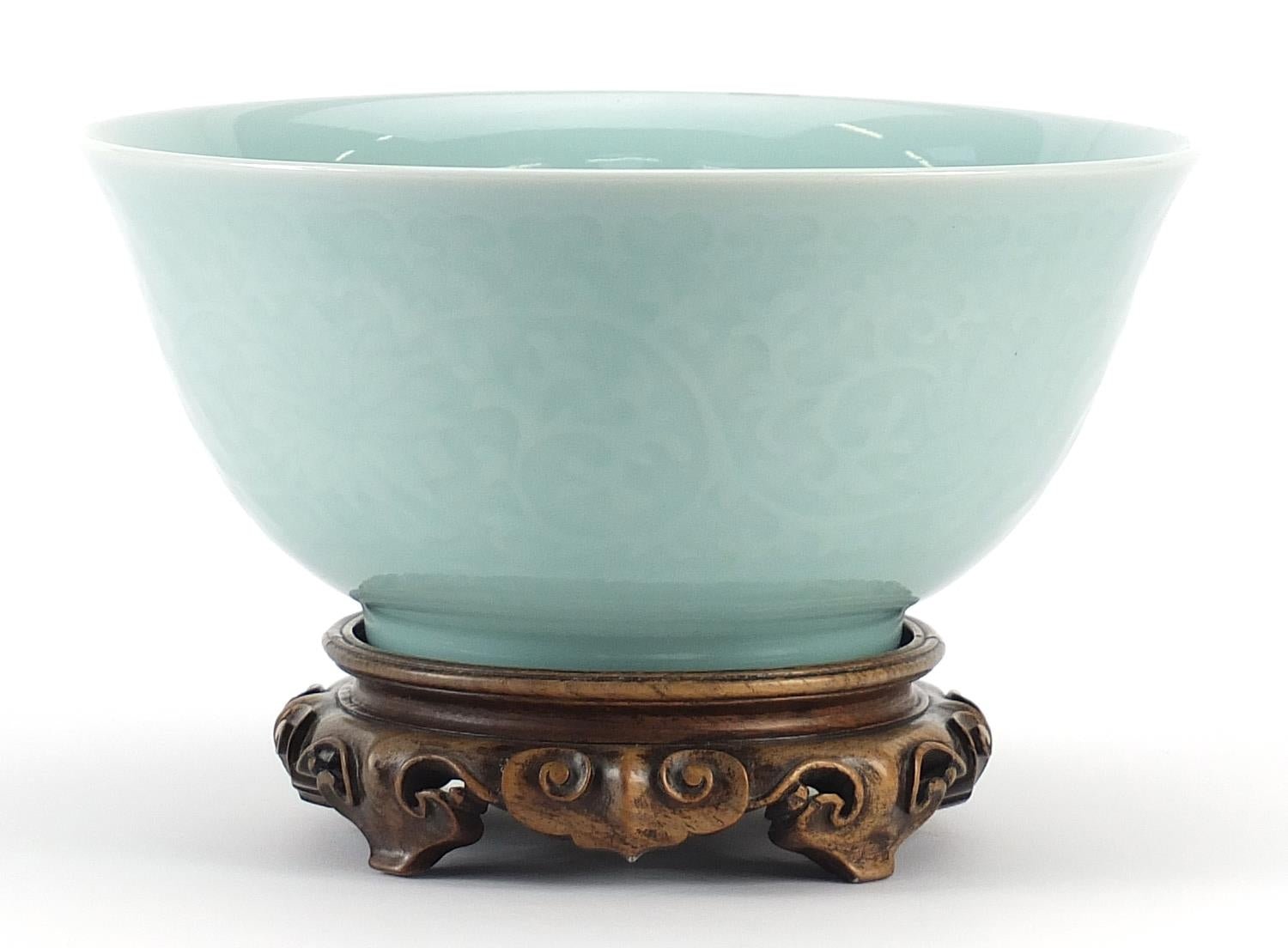 Chinese celadon bowl on a carved hardwood stand