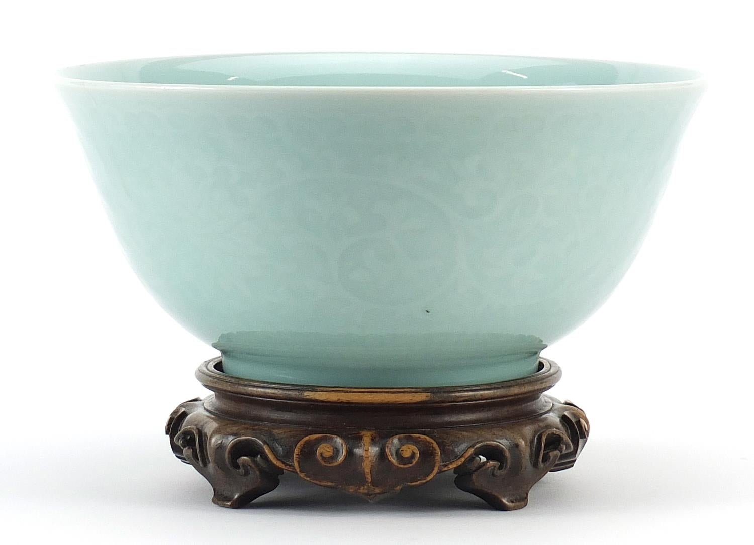 Chinese celadon bowl on a carved hardwood stand — detail 1
