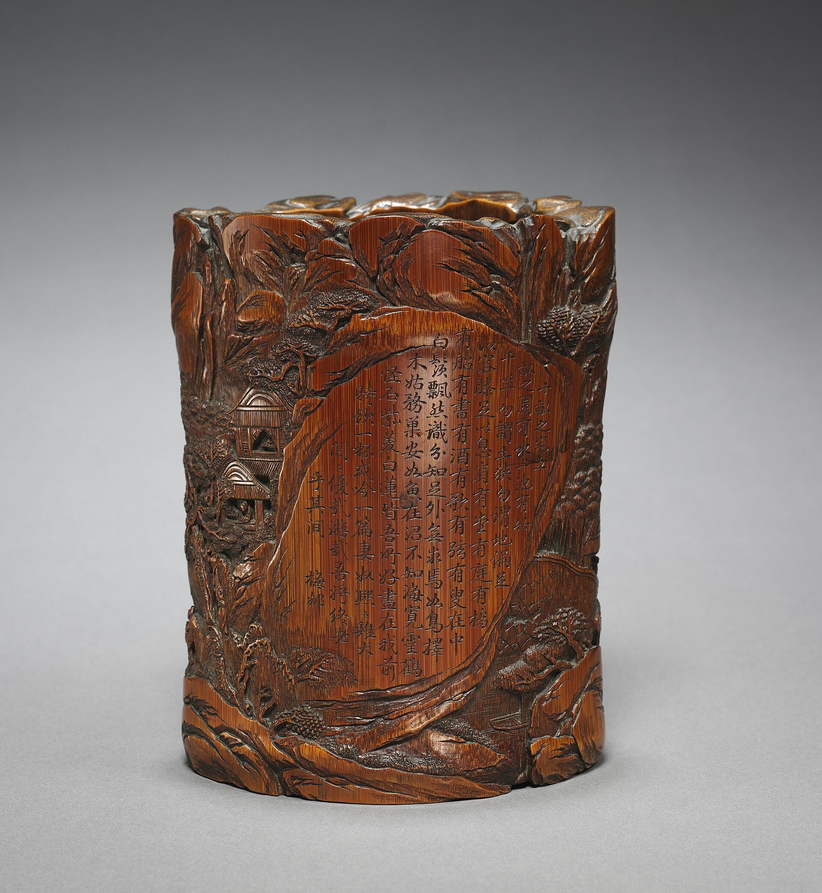 Carved bamboo brush holder with figures in a landscape and a poetic inscription