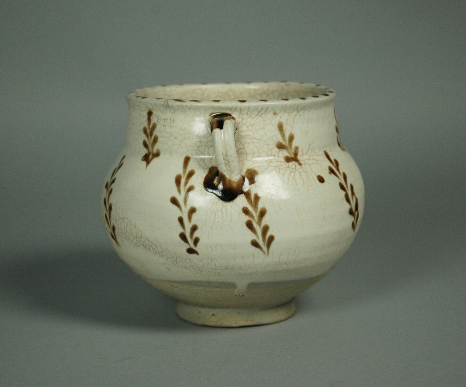 Cizhou stoneware jar painted in brown on white slip under a transparent glaze, 12th century