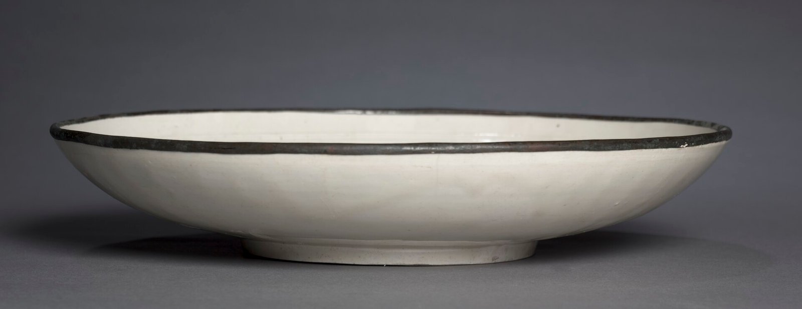 Ding ware dish, Jin dynasty, Hebei province, glazed grayish-white porcelain, 1100s, Jin. Cleveland Museum of Art, accession 1917.7.