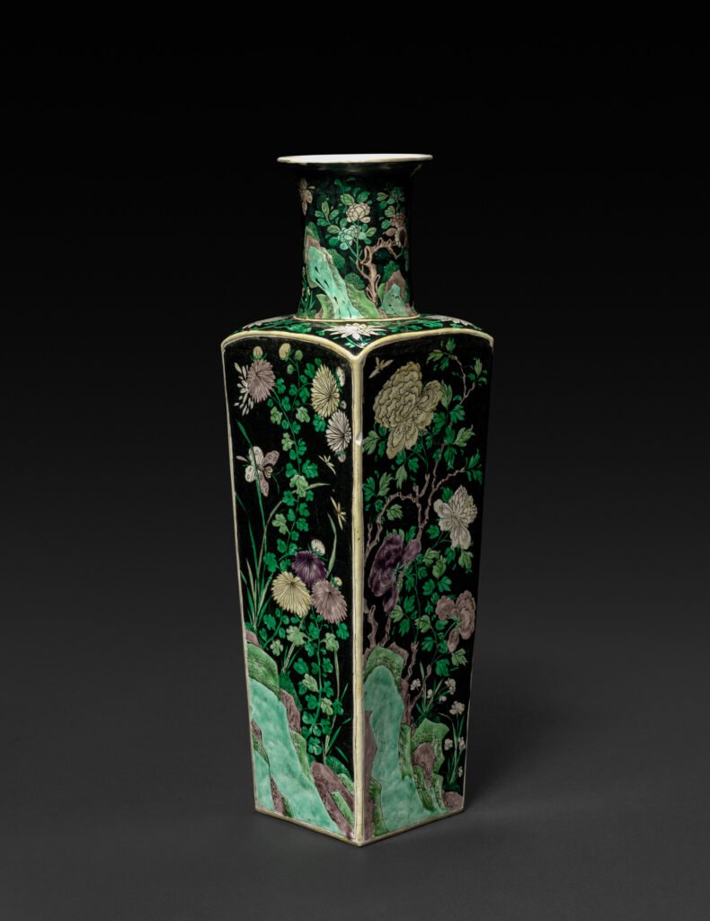 Square club-shaped porcelain vase with flowering branches reserved in green, yellow and aubergine enamels on a black ground, Kangxi reign. Cleveland Museum of Art, 1944.181.