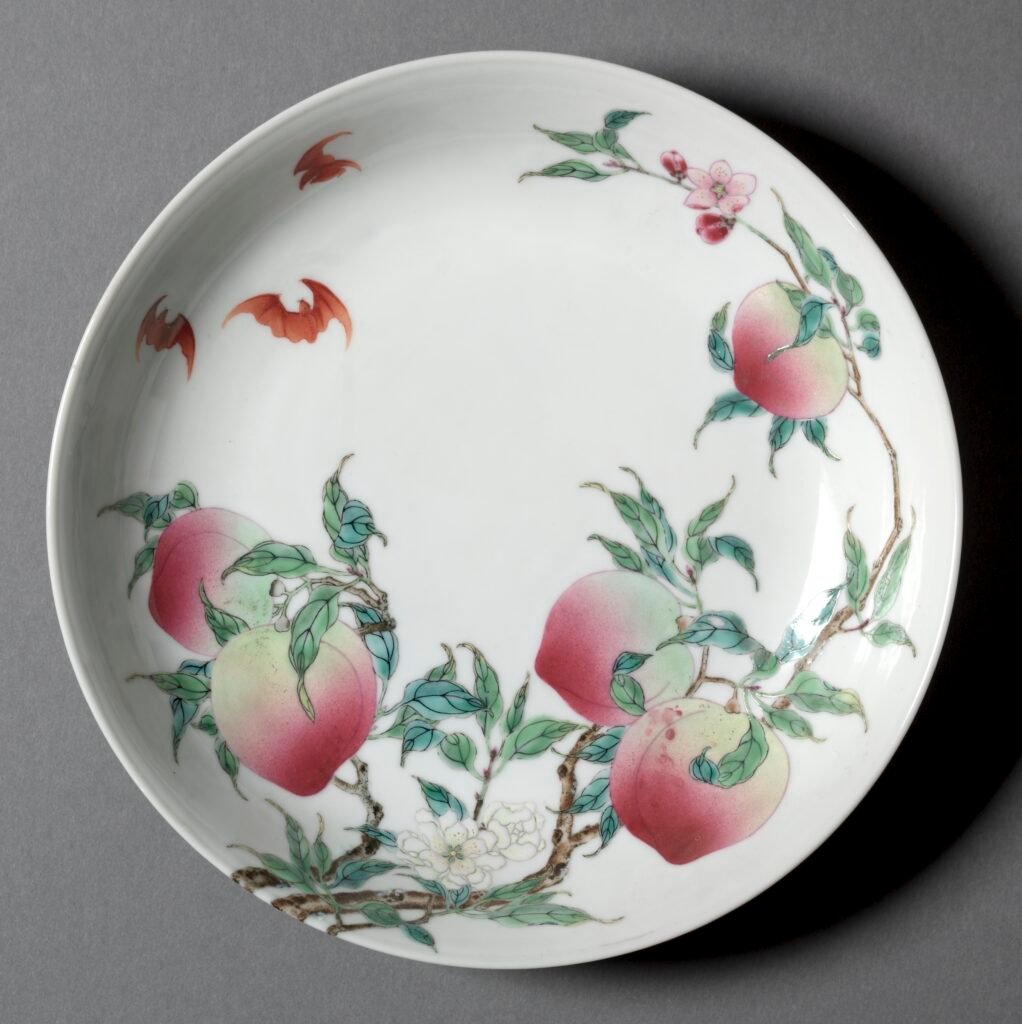 Famille rose porcelain dish painted with a peach branch and red bats on white porcelain, Yongzheng mark and reign. Cleveland Museum of Art, 1930.639.
