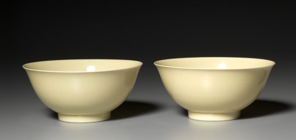 Pair of imperial yellow glazed porcelain bowls, Jingdezhen, Yongzheng mark and period 1723 to 1735. Cleveland Museum of Art, accession 2003.259, CC0.