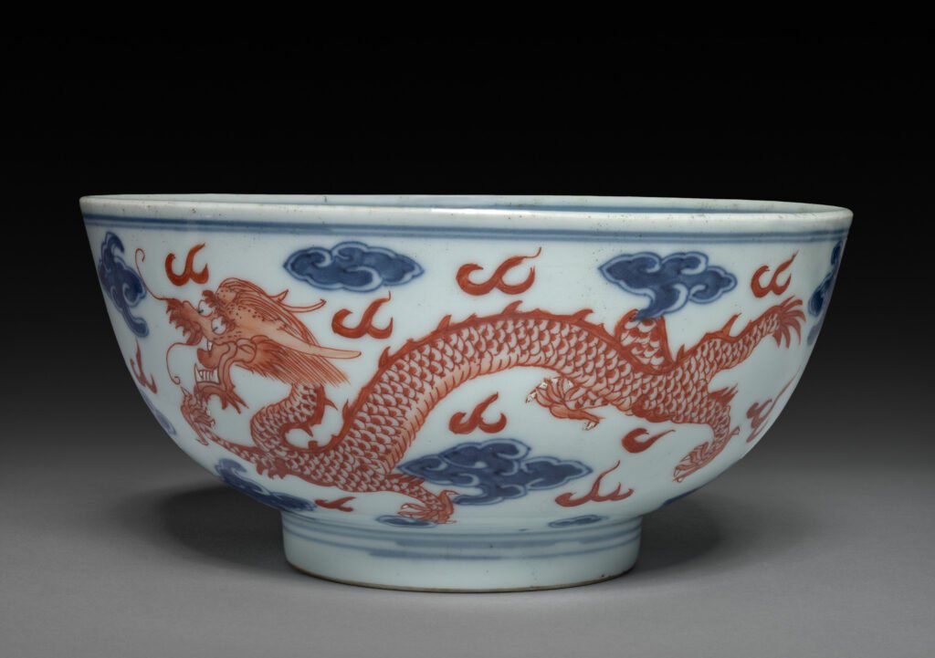 Porcelain bowl with an iron-red dragon chasing a flaming pearl among underglaze blue clouds, Qianlong mark and reign. Cleveland Museum of Art, 1974.269.