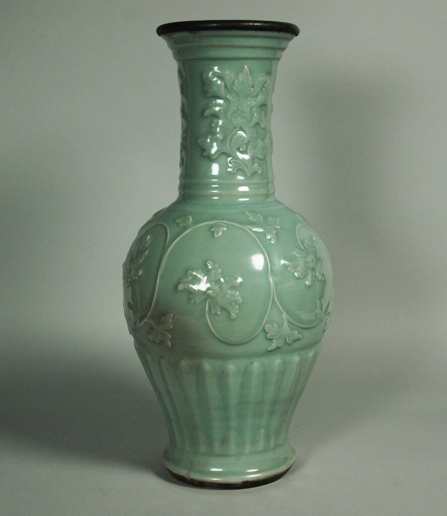 Longquan vase with moulded peony scrolls under a celadon glaze, mid-14th century Yuan dynasty. The Metropolitan Museum of Art, accession 26.292.77.