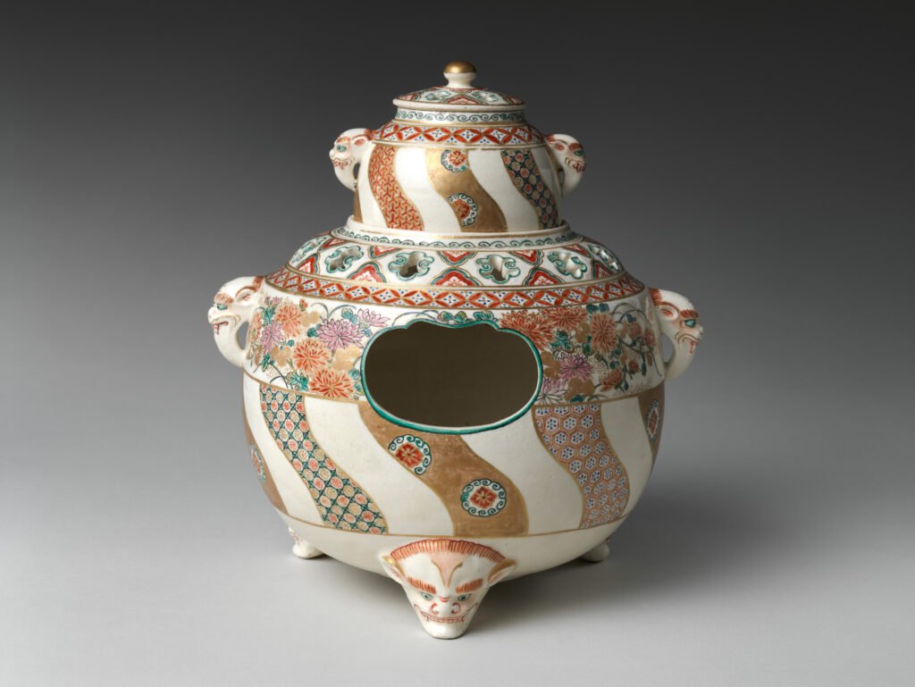 Satsuma ware clove boiler on three feet, cream crackled glaze painted with brocade bands in enamels and gold, mid nineteenth century. The Metropolitan Museum of Art, 93.3.520a–c.