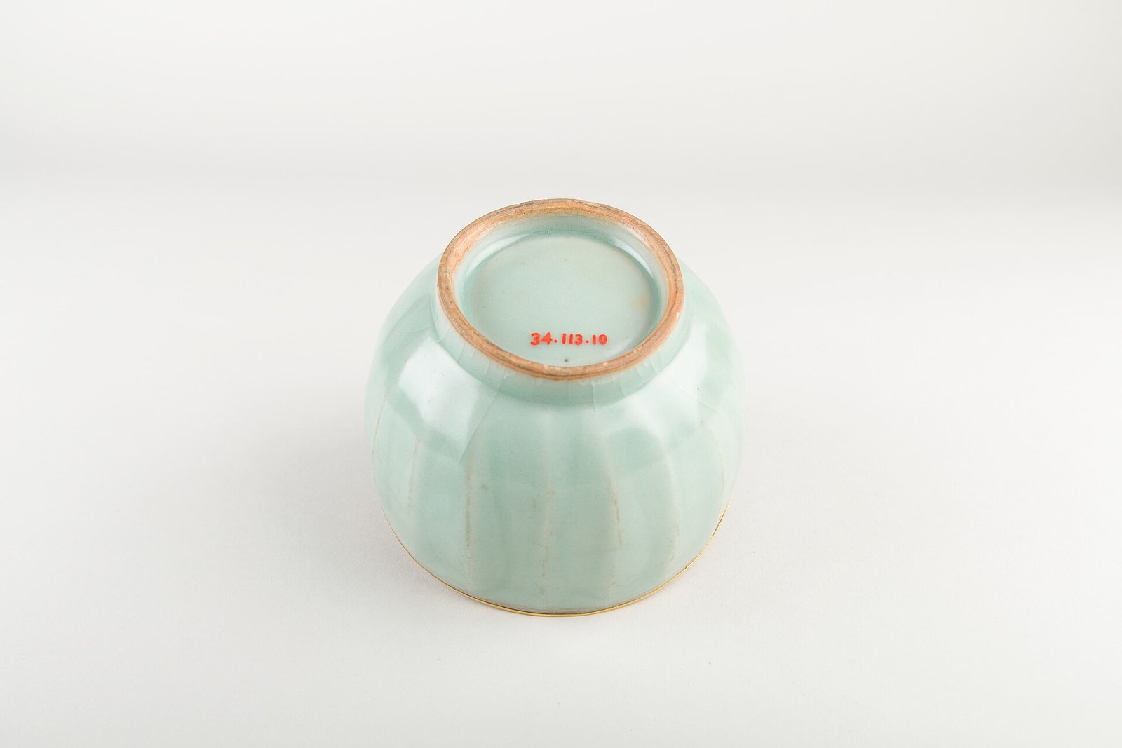 Base of a Song dynasty Longquan celadon bowl, showing the unglazed foot ring fired orange-brown